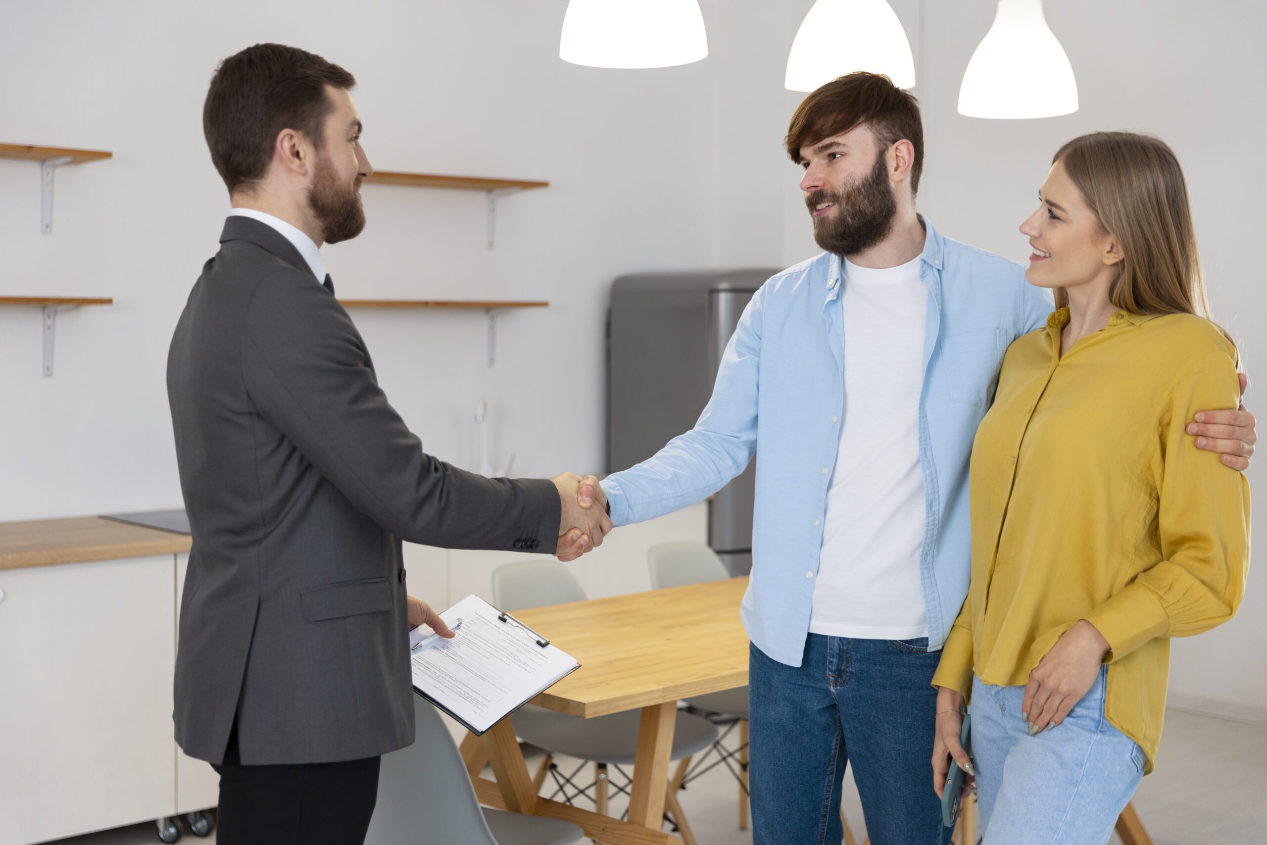 male real estate agent doing business showing house potential buying couple